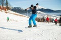 Bukovel, Ukraine - December 22, 2016: Man boarder jumping on his snowboard against the backdrop of mountains, hills and Royalty Free Stock Photo