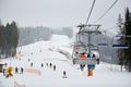 Bukovel, Ukraine - December 09, 2018: skiers sitting back, carrying down on chairlift, people skiing and snowboarding