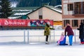 Bukovel, Ukraine February 12, 2019 - little girl roller skates with adults