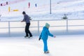 Bukovel, Ukraine February 12, 2019 - little girl roller skates with adults Royalty Free Stock Photo