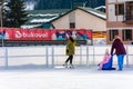 Bukovel, Ukraine February 12, 2019 - little girl roller skates with adults Royalty Free Stock Photo