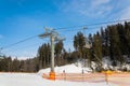 BUKOVEL, UKRAINE - FEBRUARY 28, 2018 Side view of the modern ski lift pylon in the ski resort Bukovel, Ukraine Royalty Free Stock Photo