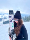 Bukovel Ukraine - February 2022 Skier woman on the ski slope resting relaxing extreme recreation active lifestyle Royalty Free Stock Photo