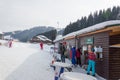 BUKOVEL, UKRAINE - FEBRUARY 28, 2018 Skiers standing near to the ticket office and buying skipasses in Bukovel, Ukraine