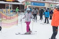 BUKOVEL, UKRAINE - FEBRUARY 28, 2018 Woman in the modern ski suite standing in the line to the ski lift in the ski resort . Royalty Free Stock Photo