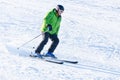 An elderly man skiing down the snowy slope Royalty Free Stock Photo