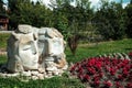 Bukovel, Ukraine - July 2020: Typical sculpture of Ukrainian couple in a rural village. Two big head statues surrounded by nature Royalty Free Stock Photo