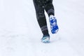 BUKOVEL, UKRAINE - MARCH 20: Female legs in Salomon speedcross 4 GTX running on winter road