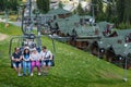 BUKOVEL, UKRAINE - MAY 27, 2018: People using the chairlift at mountain ski resort. People lift to the mountain with ski lift