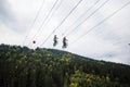 Bukovel Ukraine, September 13, 2018. People riding on bicycle on ropes by air. Concept of extreme Royalty Free Stock Photo