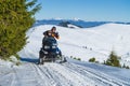 2016-12-18 Bukovel, Ukraine. Two young men on snowmobile exploration trip