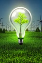 Bulb illuminating green grass, symbolizing green power, environmental protection