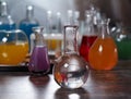 The bulb with clear water. Laboratory glassware with colorful liquids on the table Royalty Free Stock Photo