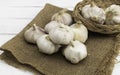 Bulb garlic on white wooden background.