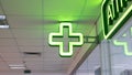 Bulb green cross indoor closeup, pharmacy pointer