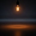 Bulb s filament is visible casting a circular pool of light on the Royalty Free Stock Photo