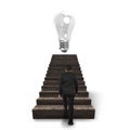 Bulb on wooden stairs with businessman climbing