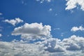 Bulbous and billowing white and dark grey clouds in the blue sky