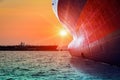 Bulbous bow ship sailing in the sea with sunset