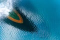 Bulbous bow of the warship sailing through the sea created wave piercing water splash with reflection of its hull and cloud above