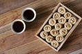 Bulbul Nest knafeh - a Middle Eastern sweet dish aysh el bolbol and Arabic coffee Qahwah with wooden background. Royalty Free Stock Photo