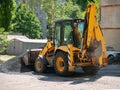 Buldozer Making and constructing a new asphalt road near the civil building. Concepts of improvement of the territory of