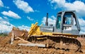 Buldozer moving earth. Road construction building work