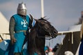 Bulgar, Russian Federation - August 2018, - athletic man in a knight`s suit sitting on a horse