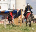 Bulgar, Russian Federation - August 2018, - two men in medieval armor riding horses on the battlefield