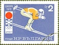 Postage stamp printed in Bulgaria with the image of mountain skier, with the inscription in Bulgarian `Sapporo, 1972`