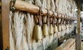 Bulgarian copper bells hanging on a wooden stick.