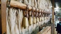 Bulgarian copper bells hanging on a wooden stick.