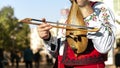 Bulgarian folk musician - violinist in traditional costume plays an old stringed instrument - gadulka. Plovdiv, Bulgaria