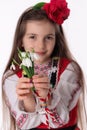 Bulgarian woman with bouquet spring snowdrop flowers and martenitsa March holiday Baba Marta, Bulgaria Royalty Free Stock Photo