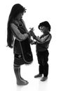 Bulgarian kids boy and girl in traditional folklore costumes with spring snowdrops, martenitsa symbol of Baba Marta