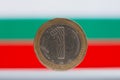 Bulgarian one LEV coin in front of Bulgarian flag Royalty Free Stock Photo
