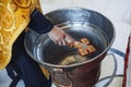 A Bulgarian priest is holding a cross over water for an orthodox baby baptism Royalty Free Stock Photo