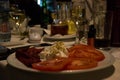 Bulgarian salad with bulgarian drink - rakiya, tomato, pepper, cheese, onion, on a table in a restaurant