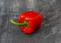 Bulgarian sweet red pepper isolated on a dark background. Kitchen vegetable screensaver