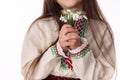 Bulgarian woman in ethnic costume with bouquepring snowdrop flowers and martenitsa Baba Marta. Bulgaria