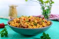 Bulgur with chicken and vegetables. Delicious healthy warm salad on a bright background Royalty Free Stock Photo