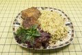 Bulgur with cutlets and green salad on the table