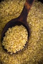 Bulgur in an old wooden spoon Royalty Free Stock Photo