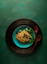 Bulgur pilaf with carrots and raisins on a blue plate on green colored background Royalty Free Stock Photo