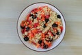 Bulgur Salad wiht different vegetables in a bowl on wooden background Royalty Free Stock Photo