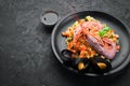 Bulgur with shrimp, mussels and vegetables. On the old background. Royalty Free Stock Photo