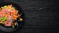Bulgur with shrimp, mussels and vegetables. On the old background. Royalty Free Stock Photo