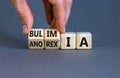 Bulimia or anorexia symbol. Doctor turns wooden cubes and changes the word anorexia to bulimia. Beautiful grey table, grey