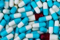 Bulk blue-white and red-white capsule pills. Contaminate in production line of pharmaceutical manufacturing. Drug interaction