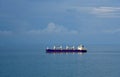 Bulk cargo ship with cranes, sailing through calm, blue ocean. Royalty Free Stock Photo